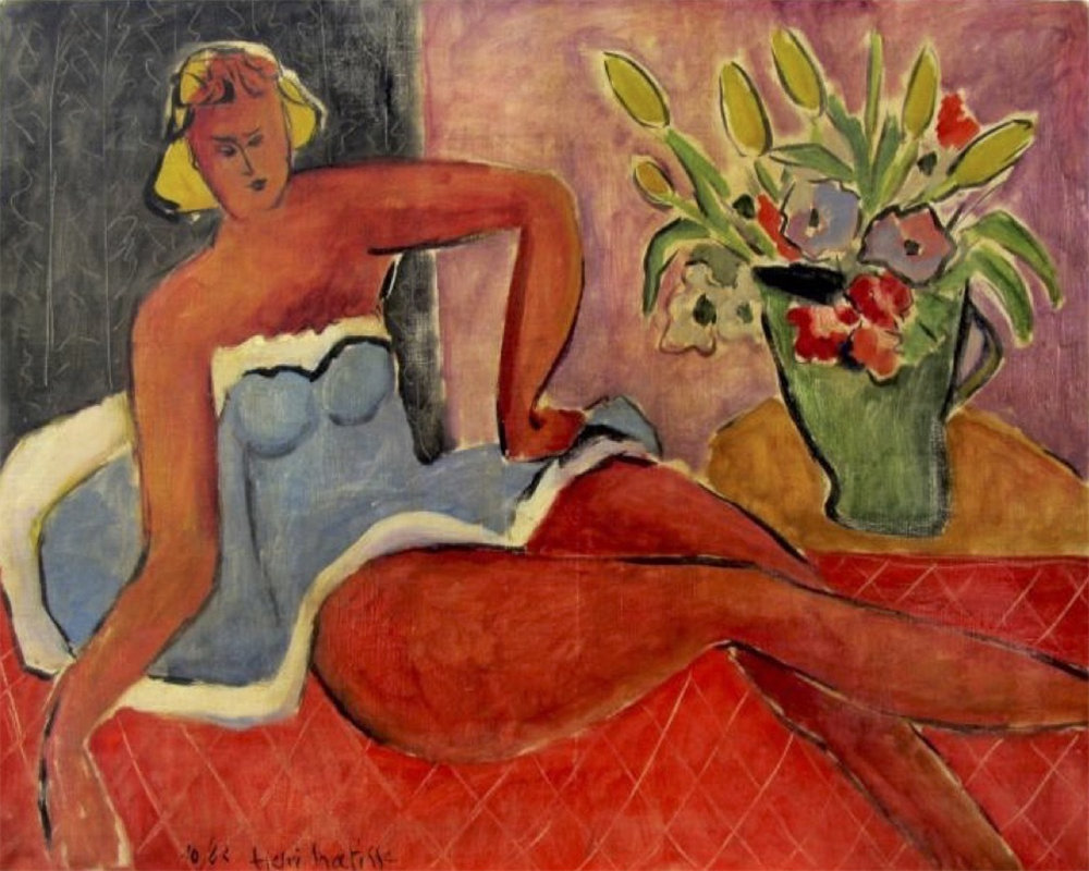 Woman Lying Close to a Vase of Flowers