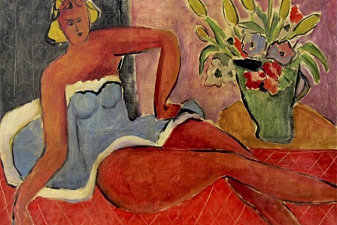 Woman Lying Close to a Vase of Flowers